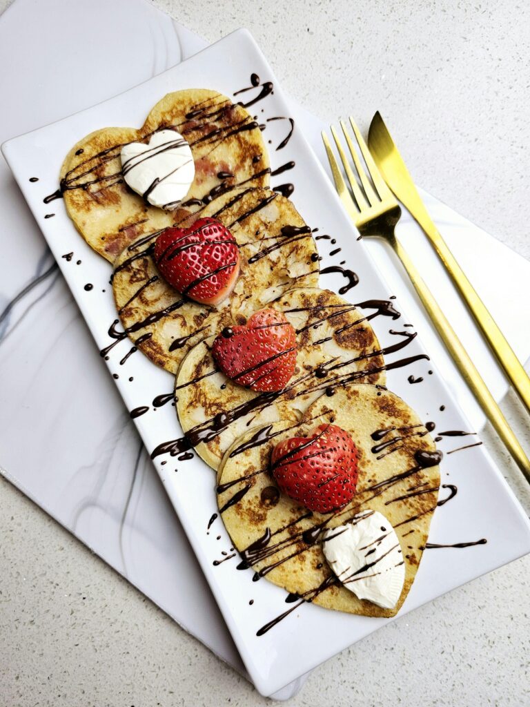 Romantic Heart-Shaped Pancakes with Strawberries and Chocolate Drizzle"